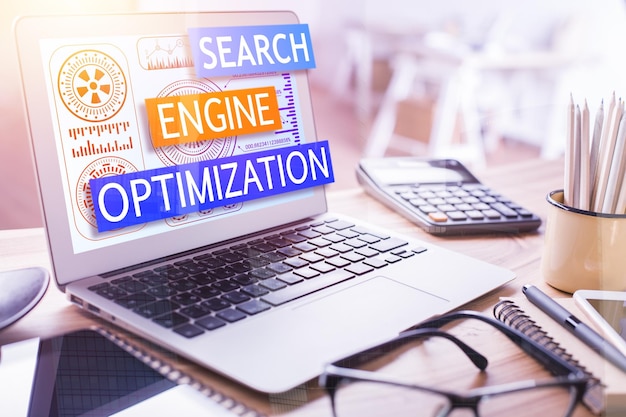 Laptop computer screen with the text "SEARCH ENGINE OPTIMIZATION"